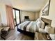 Bright bedroom with balcony access, featuring a king bed and beach-themed art for relaxation at 2710 N Ocean Blvd. # 1038, Myrtle Beach, SC 29577
