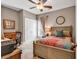 Cozy bedroom with neutral walls, a ceiling fan, and a comfortable bed with colorful quilt at 3065 Moss Bridge Ln., Myrtle Beach, SC 29579
