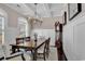 Elegant dining room with hardwood floors, coffered ceilings, wainscotting, and a grand chandelier at 3065 Moss Bridge Ln., Myrtle Beach, SC 29579