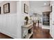 Stylish foyer with hardwood floors, white wainscoting, a decorative console table, and an open floor plan at 3065 Moss Bridge Ln., Myrtle Beach, SC 29579