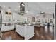 Open concept kitchen features granite counters, white cabinets, and stainless steel appliances at 3065 Moss Bridge Ln., Myrtle Beach, SC 29579