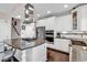Open concept kitchen features granite counters, white cabinets, and stainless steel appliances at 3065 Moss Bridge Ln., Myrtle Beach, SC 29579