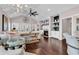 Cozy living room featuring vaulted ceilings, a fireplace, hardwood floors, and open to kitchen at 3065 Moss Bridge Ln., Myrtle Beach, SC 29579