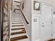 Staircase with white risers, wooden treads, and wainscoting at 3065 Moss Bridge Ln., Myrtle Beach, SC 29579