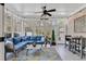 Bright sunroom with a seating area, string lights, and many large windows at 3065 Moss Bridge Ln., Myrtle Beach, SC 29579