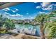 Backyard view showcasing a waterfront deck with seating overlooking scenic canal and homes at 321 52Nd Ave. N, North Myrtle Beach, SC 29582