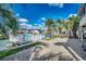 Waterfront backyard featuring a brick patio, lush palm trees, and serene views of the canal at 321 52Nd Ave. N, North Myrtle Beach, SC 29582