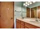 Bathroom with double sinks, wooden cabinets, and a large mirror at 321 52Nd Ave. N, North Myrtle Beach, SC 29582