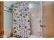 Bathroom with a bathtub, shower, and colorful fish-themed shower curtain at 321 52Nd Ave. N, North Myrtle Beach, SC 29582