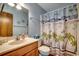 A charming bathroom with a vanity, sailboat-themed shower curtain, and decorative accents at 321 52Nd Ave. N, North Myrtle Beach, SC 29582