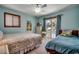 Comfortable bedroom with two beds, neutral carpet, window with blinds, and sliding glass doors to balcony at 321 52Nd Ave. N, North Myrtle Beach, SC 29582