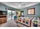 A cozy bedroom with a colorful quilt, wicker dresser, and access to the outdoor balcony at 321 52Nd Ave. N, North Myrtle Beach, SC 29582