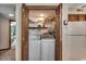 Dedicated laundry area with washer, dryer, and shelving for storage solutions at 321 52Nd Ave. N, North Myrtle Beach, SC 29582