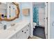 Well-lit bathroom with a white vanity, ornate mirror, and a shower/tub combo with a seashell-themed curtain at 351 Lake Arrowhead Rd. # 12-347, Myrtle Beach, SC 29572