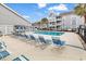Community swimming pool with lounge chairs and palm trees at 351 Lake Arrowhead Rd. # 12-347, Myrtle Beach, SC 29572
