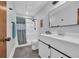 Updated bathroom featuring a modern vanity with sliding doors and a shower with a patterned curtain at 3700 Golf Colony Lane # 18-I, Little River, SC 29566