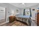 Serene bedroom with wood-look flooring, a cozy bed, and pleasant natural light at 3700 Golf Colony Lane # 18-I, Little River, SC 29566