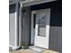 Home entrance with welcome mat, front door, and muted blue and gray accents at 3700 Golf Colony Lane # 18-I, Little River, SC 29566