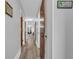 Long hallway with neutral walls, wood-look floors, and doors leading to various rooms at 3700 Golf Colony Lane # 18-I, Little River, SC 29566