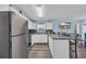 Bright kitchen with stainless steel appliances, white cabinets, and an island bar with seating at 3700 Golf Colony Lane # 18-I, Little River, SC 29566