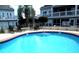 Inviting community pool with lounge chairs, tables and a relaxing spot to unwind at 3700 Golf Colony Lane # 18-I, Little River, SC 29566
