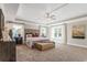 Spacious bedroom featuring tray ceilings, a ceiling fan, and large windows for natural light at 4008 Bucolic Loop, Myrtle Beach, SC 29588