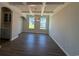 Dining room with coffered ceilings, wood-look floors, chandelier, and two large windows at 4008 Bucolic Loop, Myrtle Beach, SC 29588