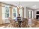 Bright dining area with hardwood floors, large windows, a round table, and wicker chairs at 4008 Bucolic Loop, Myrtle Beach, SC 29588