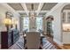 Elegant dining room featuring coffered ceilings, a long wooden table, and large windows at 4008 Bucolic Loop, Myrtle Beach, SC 29588