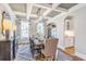 Stylish dining room featuring coffered ceilings, dark wood table, and elegant decor with a view into the kitchen at 4008 Bucolic Loop, Myrtle Beach, SC 29588