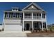 Two-story home with white siding, covered porch, black shutters, and an attached two car garage at 4008 Bucolic Loop, Myrtle Beach, SC 29588