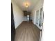 Bright foyer with wood-look floors, staircase, and glass french doors at 4008 Bucolic Loop, Myrtle Beach, SC 29588