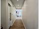 Well-lit hallway with wood-look flooring, white walls and doors, and access to various rooms at 4008 Bucolic Loop, Myrtle Beach, SC 29588