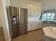Kitchen featuring stainless steel fridge and white cabinets with white subway tile backsplash at 4008 Bucolic Loop, Myrtle Beach, SC 29588