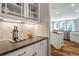 Butlers pantry with under cabinet lighting, a tile backsplash, and light grey countertops at 4008 Bucolic Loop, Myrtle Beach, SC 29588