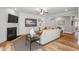Cozy living room featuring hardwood floors, a fireplace, a ceiling fan, and access to the dining room at 4008 Bucolic Loop, Myrtle Beach, SC 29588