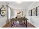 Home office with hardwood floors, a large desk, neutral walls with white trim, and a horse painting at 4008 Bucolic Loop, Myrtle Beach, SC 29588