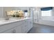 Well-lit bathroom with double vanity, quartz countertop, and glass enclosed shower with soaking tub at 4035 Bucolic Loop, Myrtle Beach, SC 29588
