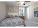 Carpeted bedroom with a ceiling fan, large window, and a comfortable bed with decorative pillows at 4035 Bucolic Loop, Myrtle Beach, SC 29588