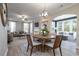 Open floor plan featuring a dining area with views into the living room, with hard wood floors and an arched entryway at 4035 Bucolic Loop, Myrtle Beach, SC 29588