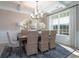 Dining room featuring a modern chandelier, hardwood floors and a large window at 4035 Bucolic Loop, Myrtle Beach, SC 29588