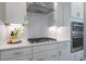 Modern kitchen with a stainless steel range hood, gas cooktop, and white subway tile backsplash at 4035 Bucolic Loop, Myrtle Beach, SC 29588