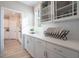 Bright kitchen showing white countertops, a plate rack, and decorative glass-front cabinets at 4035 Bucolic Loop, Myrtle Beach, SC 29588