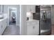 Bright kitchen with stainless steel refrigerator, white cabinets and view to dining area at 4035 Bucolic Loop, Myrtle Beach, SC 29588