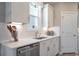 Kitchen view highlighting white cabinets, stainless steel dishwasher, and under-cabinet lighting at 4035 Bucolic Loop, Myrtle Beach, SC 29588