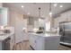 Modern kitchen featuring stainless steel appliances, a kitchen island, and sleek white cabinetry at 4035 Bucolic Loop, Myrtle Beach, SC 29588