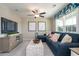 Inviting living room with a comfortable blue sofa, neutral tones, and ample natural light at 4035 Bucolic Loop, Myrtle Beach, SC 29588