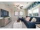 Carpeted living room with a dark blue sofa, decorative pillows, and a large window for natural light at 4035 Bucolic Loop, Myrtle Beach, SC 29588
