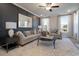 Spacious living room with neutral furniture, dark accent wall, and large windows providing natural light at 4035 Bucolic Loop, Myrtle Beach, SC 29588