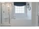 Bright main bathroom with a walk-in shower, garden tub, and white tile surround, offering a spa-like retreat at 4035 Bucolic Loop, Myrtle Beach, SC 29588